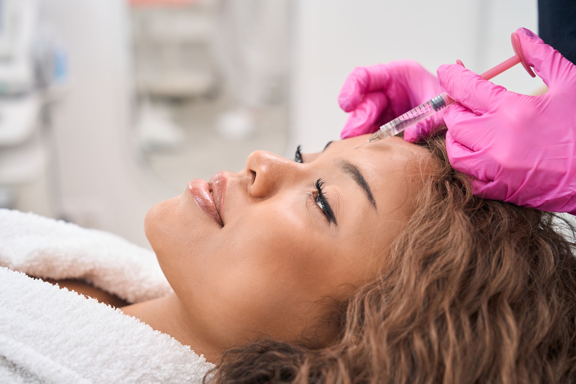 Modern woman receives botulinum toxin injections in a cosmetology clinic